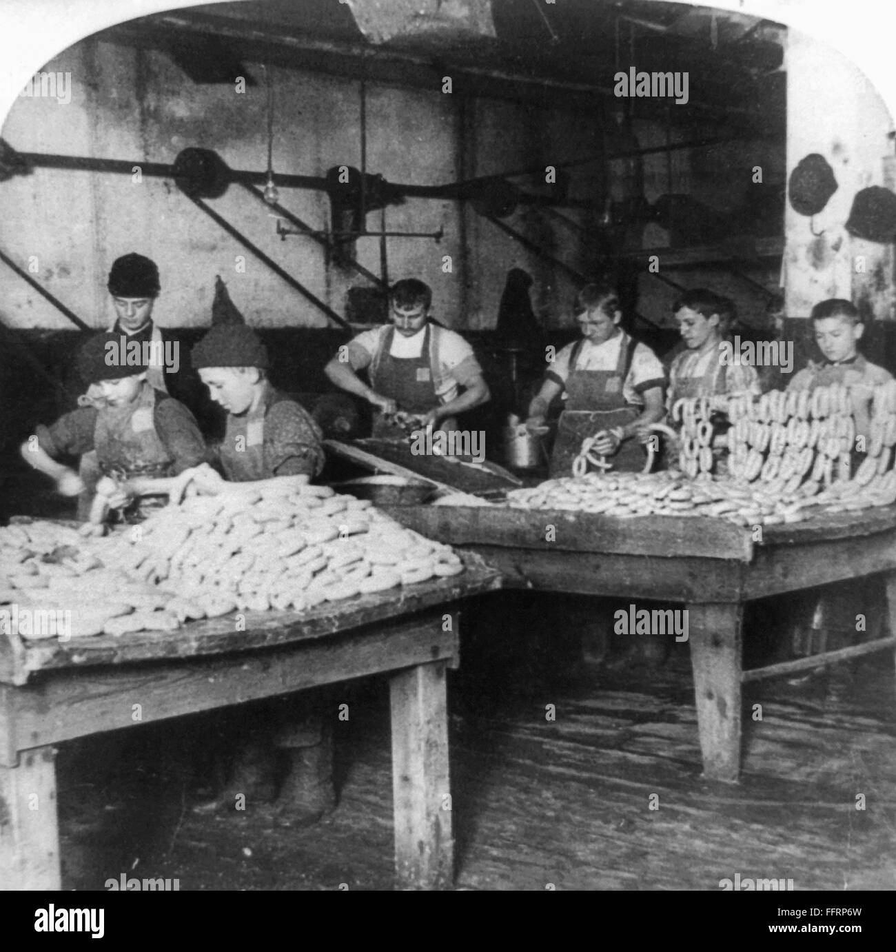 CHICAGO: MEATPACKING. /nMen and boys stuffing skins on two tables in the sausage department at the Armour and Company meatpacking house in Chicago, Illinois. Stereograph, c1893. Stock Photo