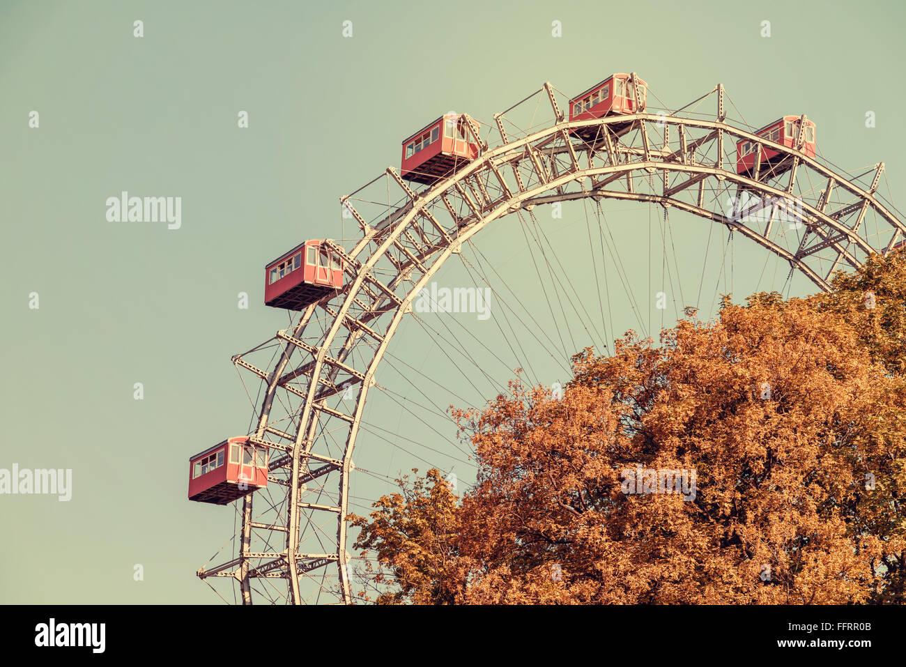 Retro Filter Of Fun Park Ferris Wheel Against Blue Sky In Prater Park Vienna Stock Photo