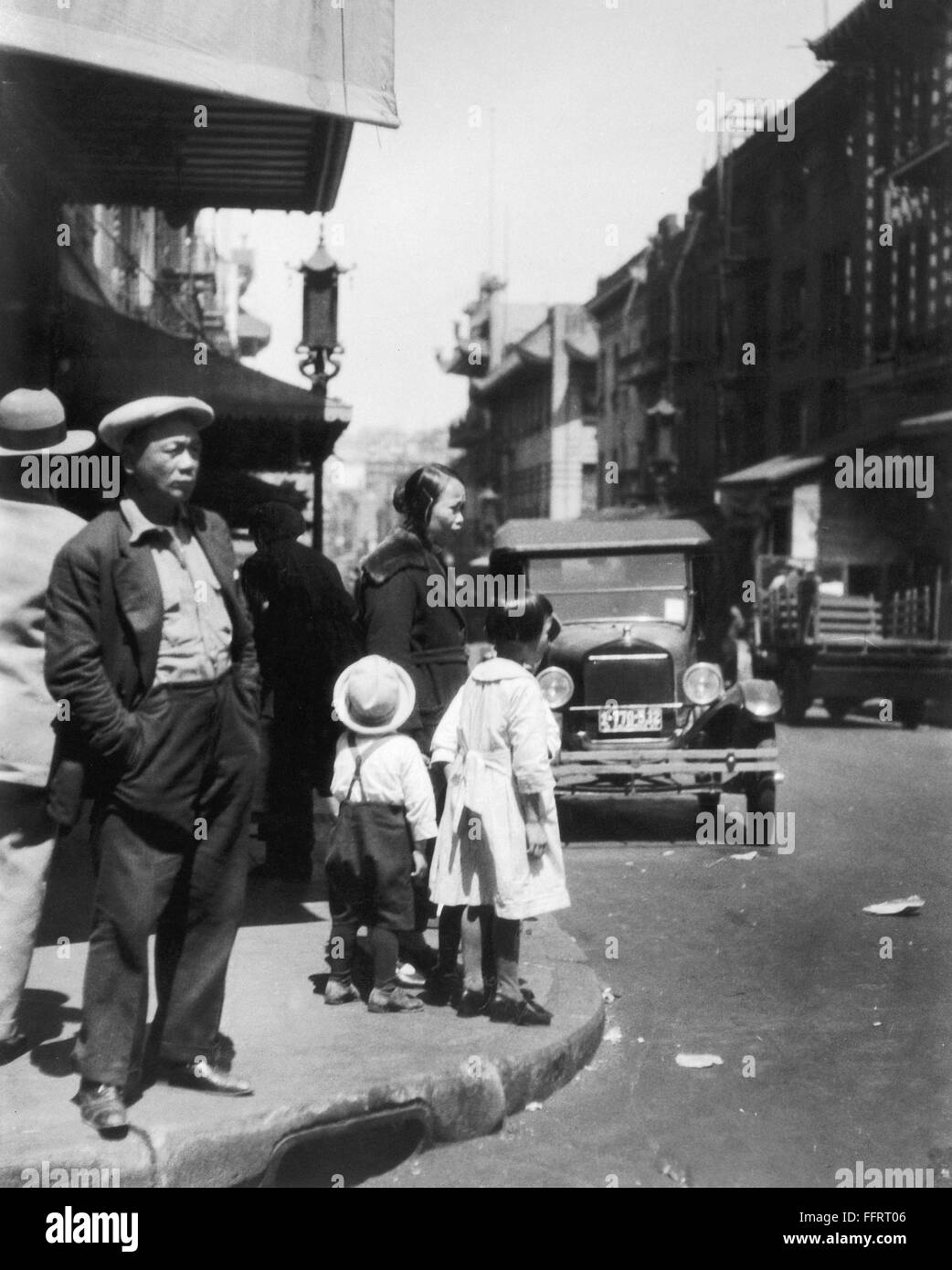 SAN FRANCISCO CHINATOWN. /nChinese immigrants standing on a street