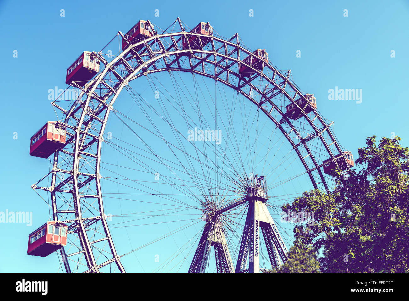 Retro Filter Of Fun Park Ferris Wheel Against Blue Sky In Prater Park Vienna Stock Photo