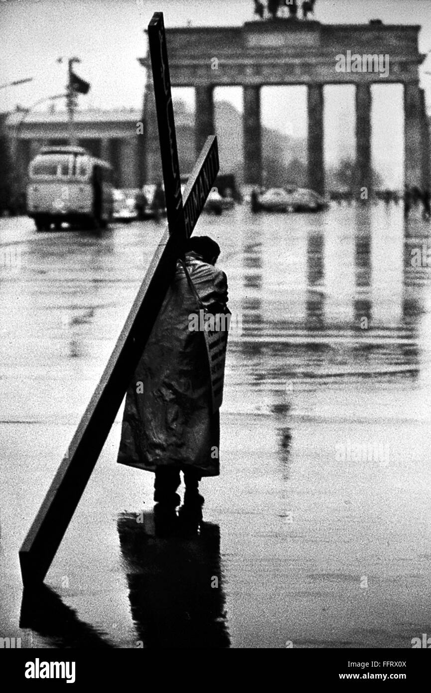 BERLIN: MAN AND CROSS, 1961. /nA man carrying a cross on a street in West Berlin, near the Brandenburg Gate. Photographed by Tony Frissell, October 1961. Stock Photo