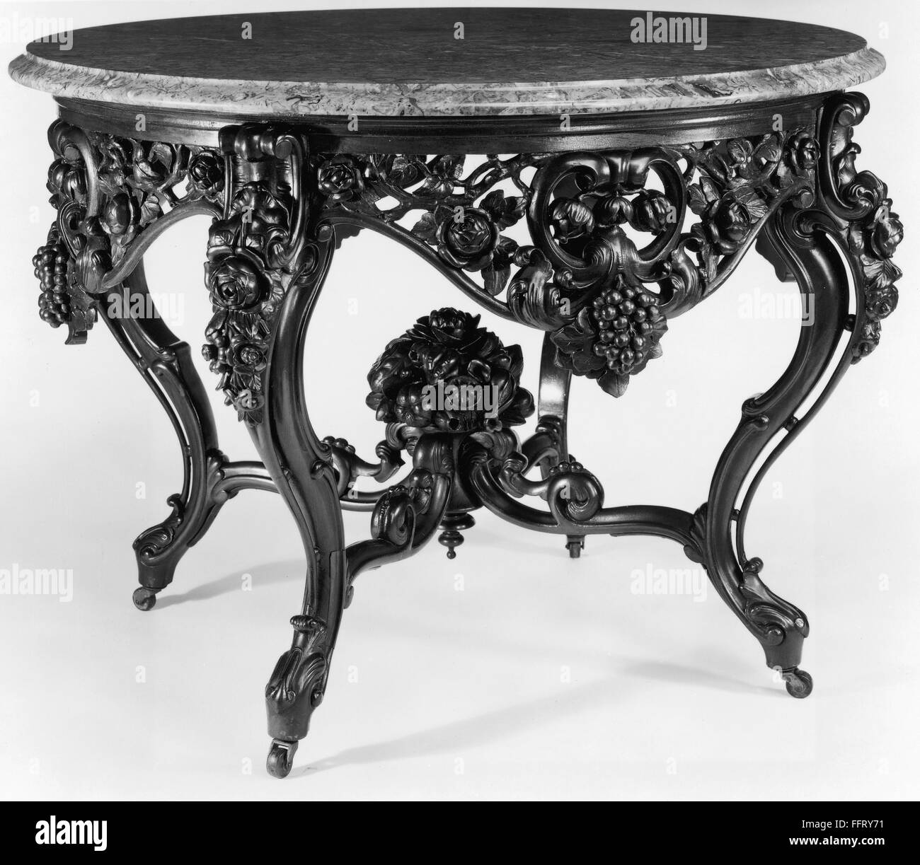 VICTORIAN PARLOR TABLE. /nAmerican Victorian Rococo center table, rosewood with marble top, labeled by John Henry Belter, New York, 1856-1861. Stock Photo