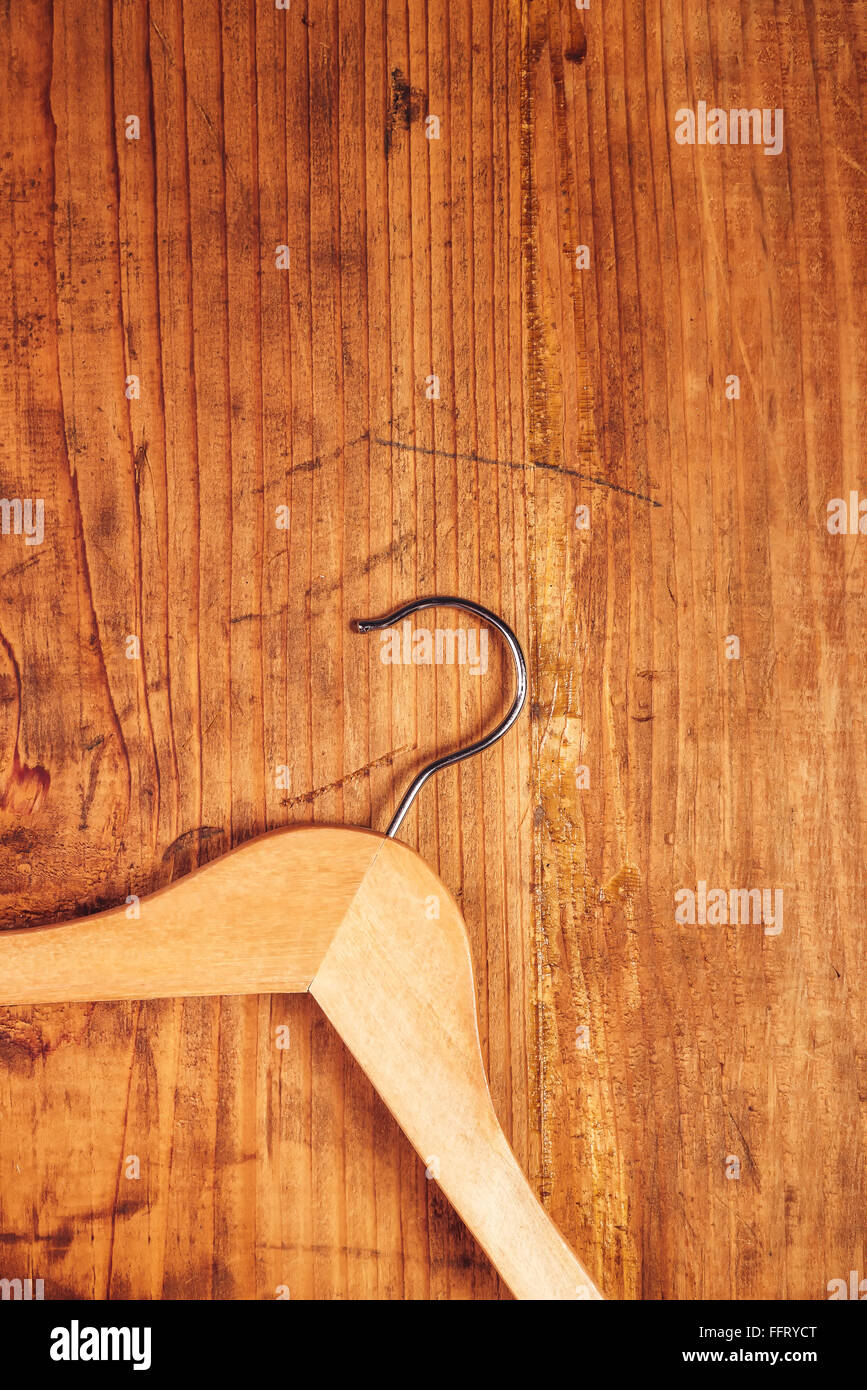 Retro cloth hanger on rustic wooden background, top view with copy space Stock Photo