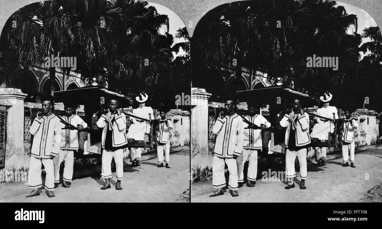 CHINA: PALANQUIN, 1902. /nPalanquin bearers in Canton, China, carrying U.S. Consul General Robert McWade and his wife. Stereograph, 1902. Stock Photo