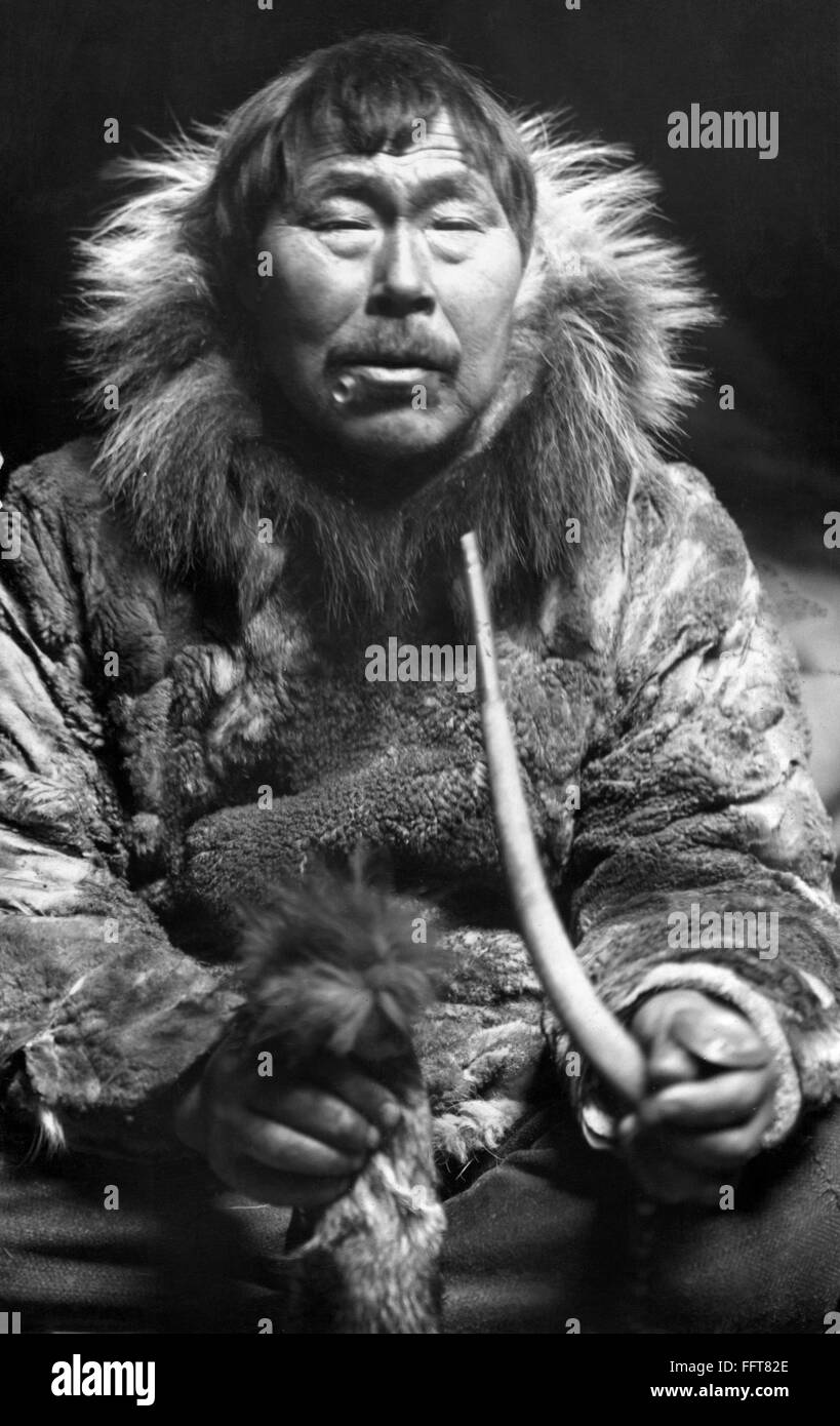 ALASKA ESKIMO MAN. /nEskimo man smoking a pipe, in fur clothing. Photograph, early/n20th