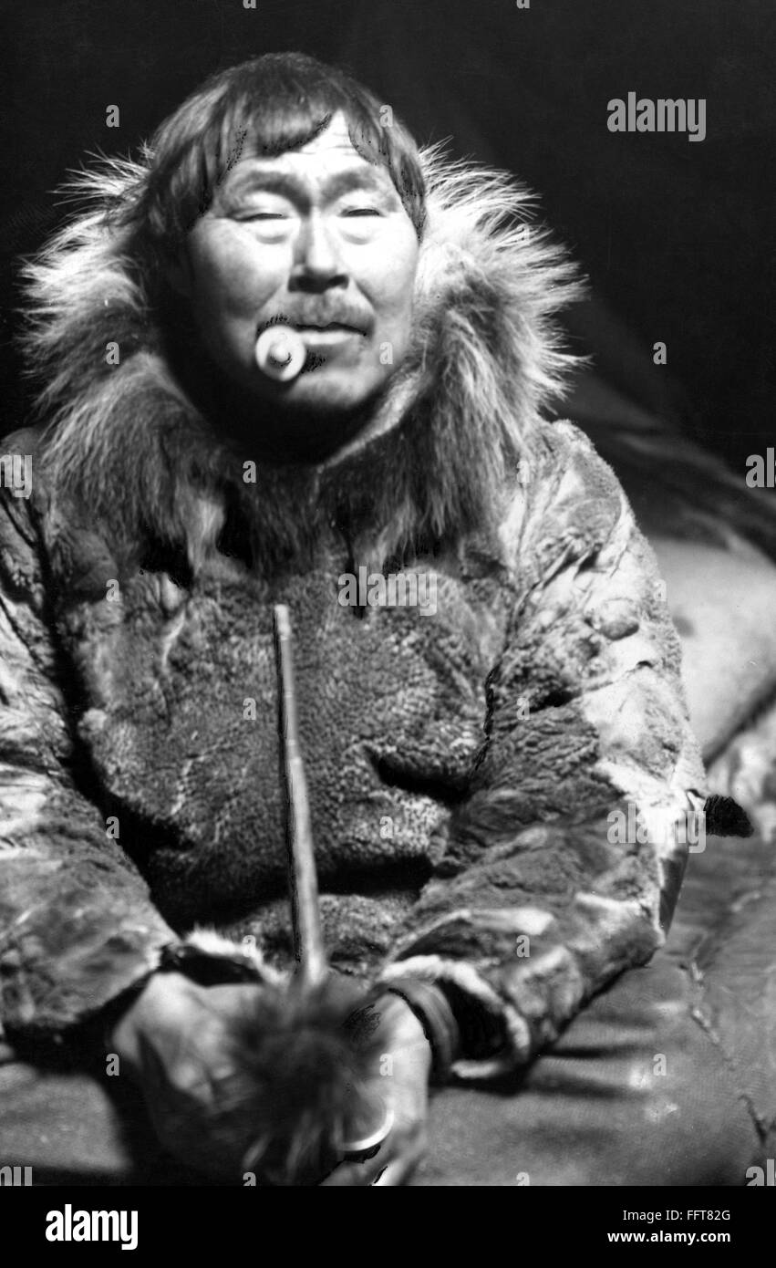 ALASKA ESKIMO MAN. /nA portrait of a man smoking a pipe, in fur clothing. Photograph, early