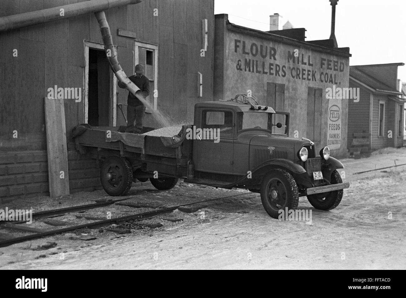 IOWA CORN MILL, 1936. /nLoading corn kernels onto a truck from an