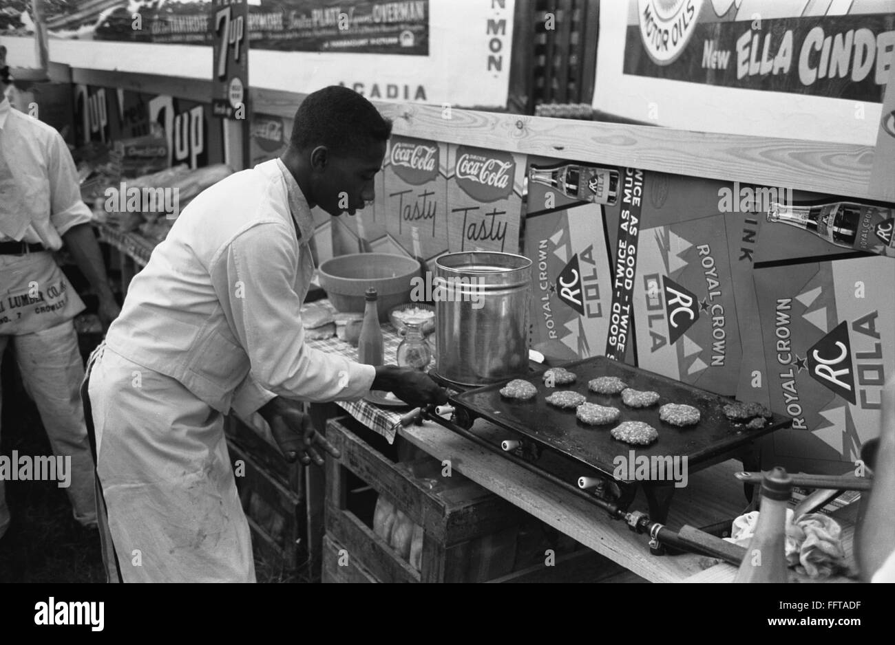 HAMBURGER GRILL, 1938. /nA cook making hamburgers in a concession stand
