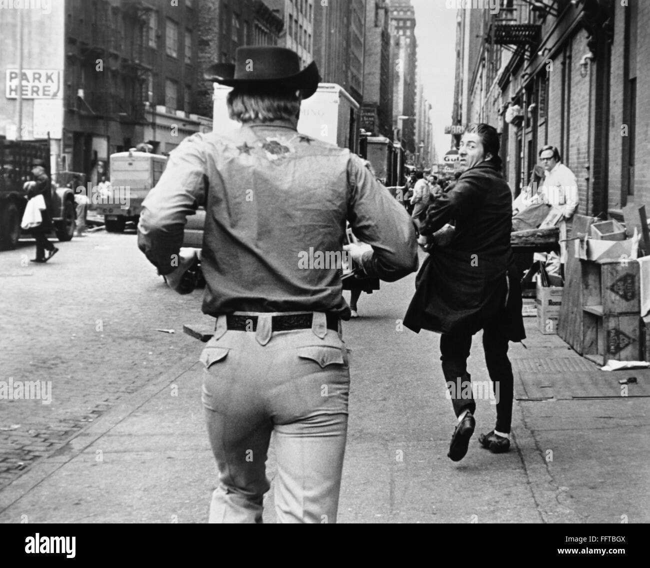 MIDNIGHT COWBOY,1969. /nJohn Voight as the cowboy, front, and Dustin Hoffman as 'Ratso Rizzo' in