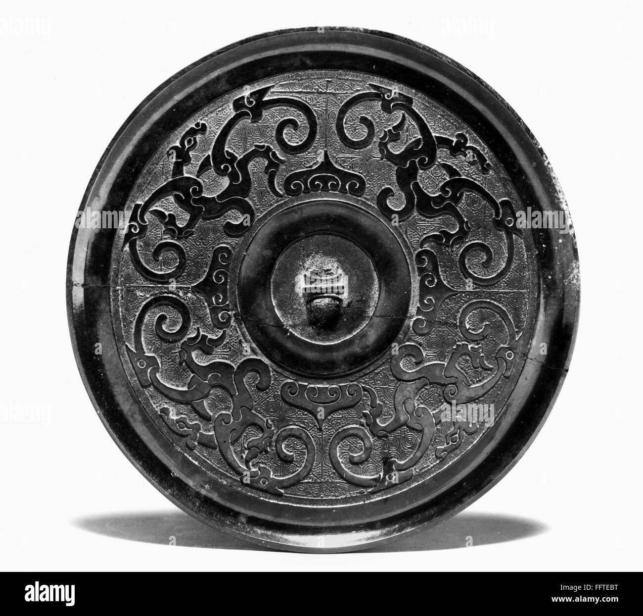 CHINA BRONZE MIRROR. /nBronze mirror with spiraling dragon pattern