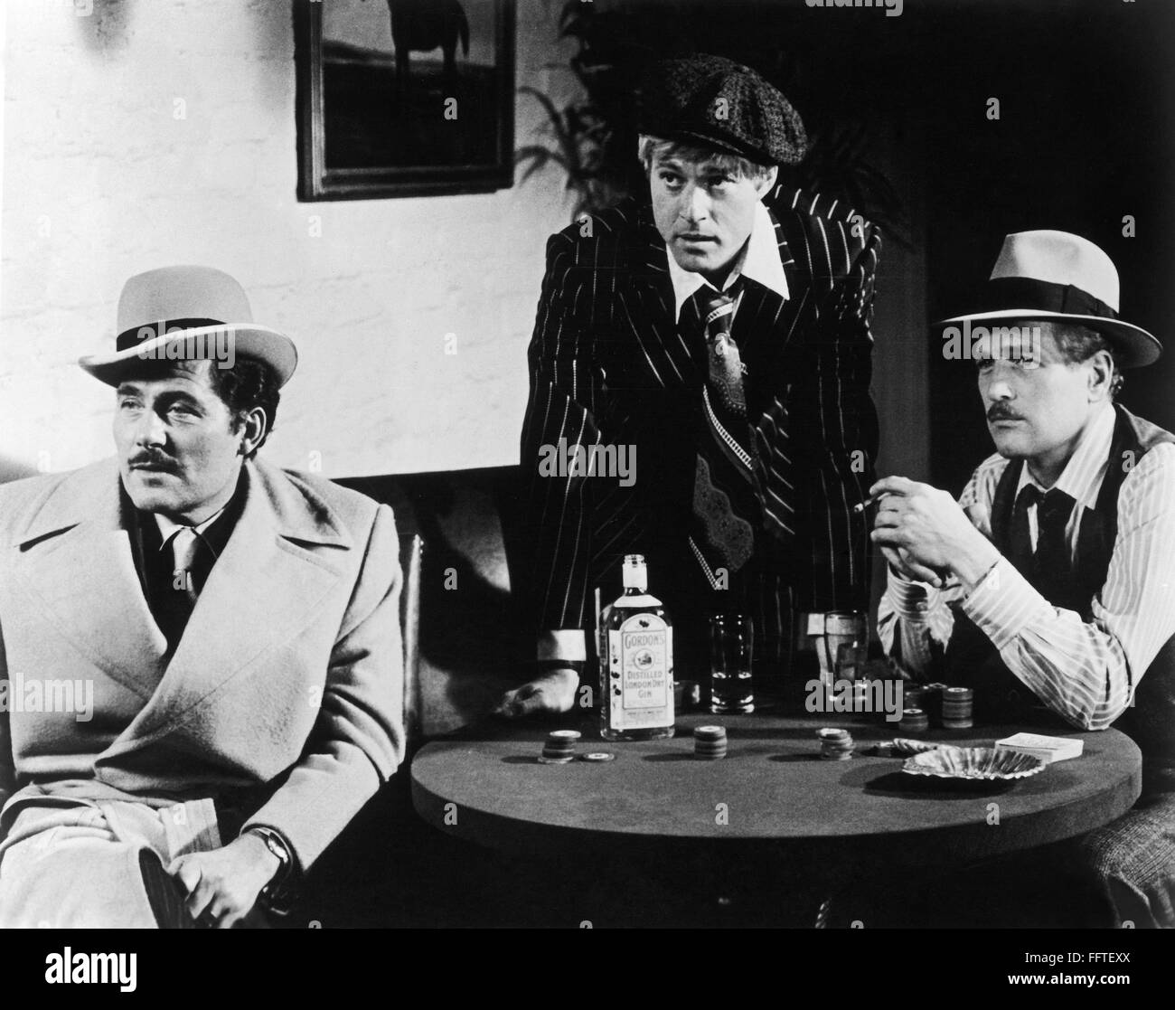 FILM: THE STING, 1973. /nRobert Redford, standing, and Paul Newman, right, as two grifters, and Robert Shaw as a mob boss in 'The Sting' directed by George Roy Hill, 1973. Stock Photo