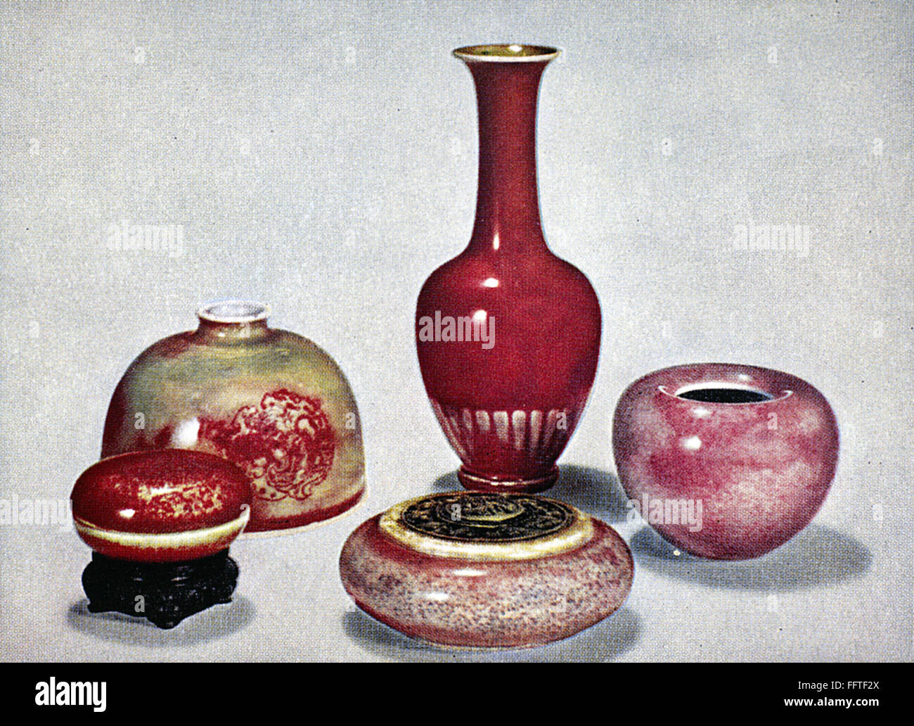 CHINA: GLAZED CERAMICS. /nBottle vase (center) and other porcelain items with pinkish red 'peach bloom' glaze. K'ang Hsi period, Ching Dynasty, 1661-1722. Stock Photo