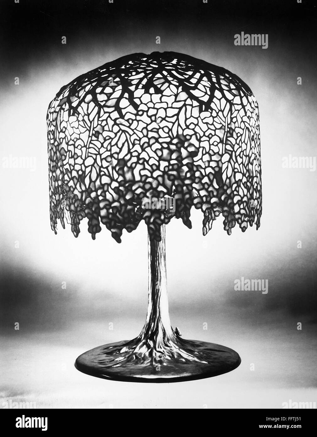 TIFFANY LAMP. /nWisteria leaded glass and bronze table lamp in the form of a tree, by Louis Comfort Tiffany, c1900. Stock Photo