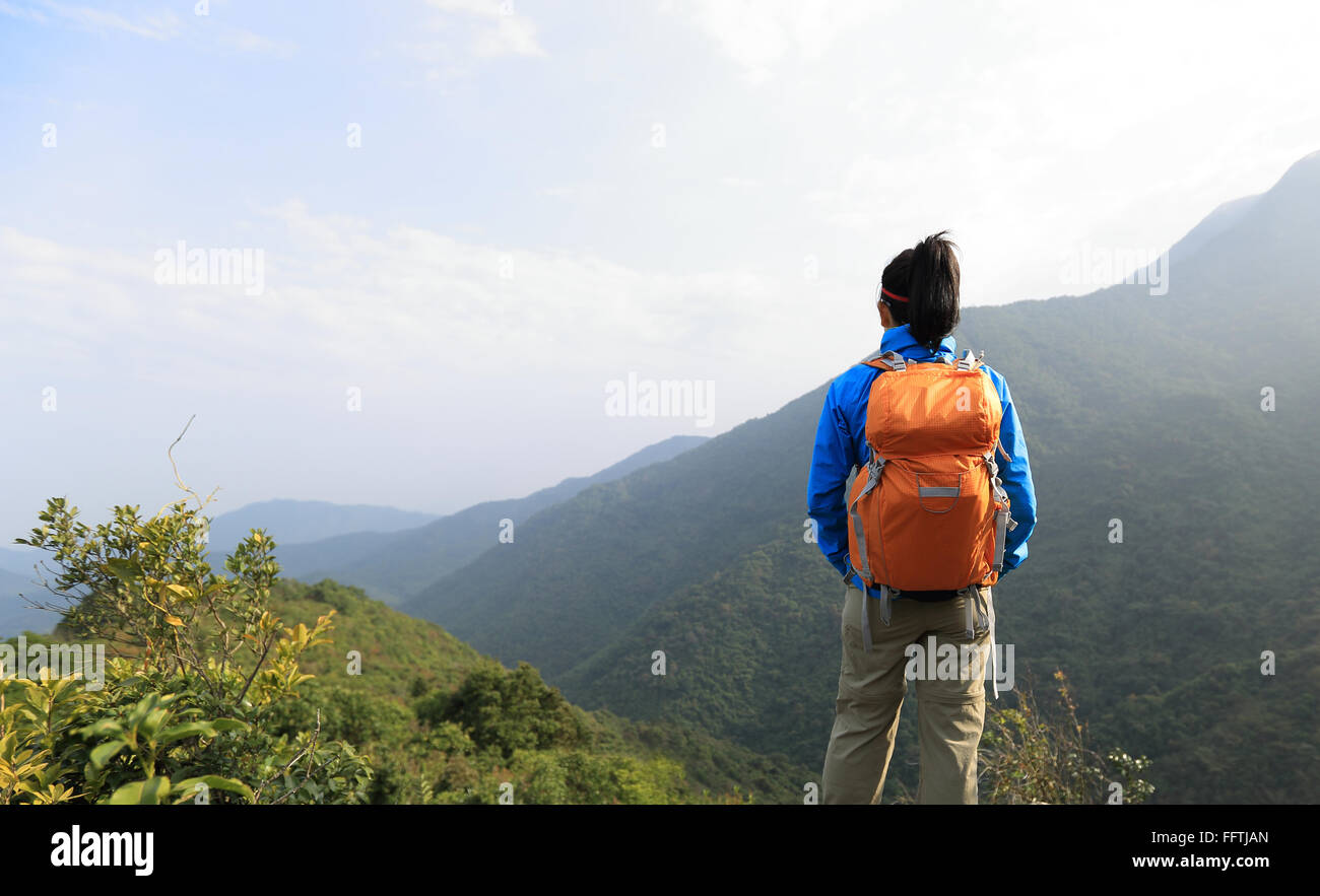 young woman hiker hiking at mountain peak Stock Photo - Alamy