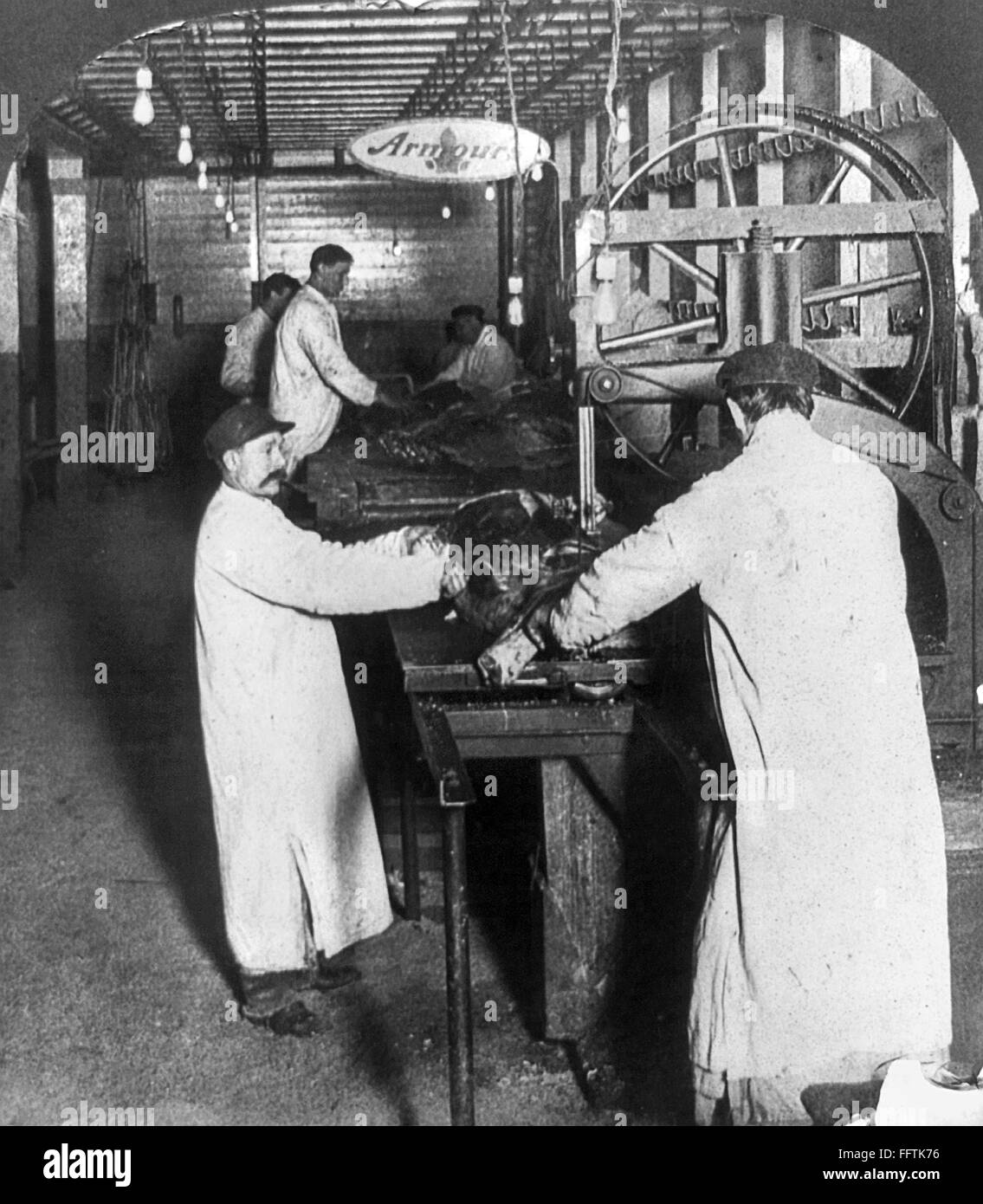 CHICAGO MEATPACKING. /nFactory workers using the beef cutting machine