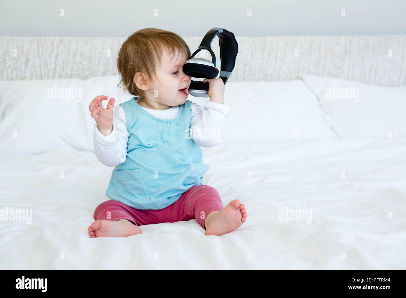 Baby with headphones hi-res stock photography and images - Alamy