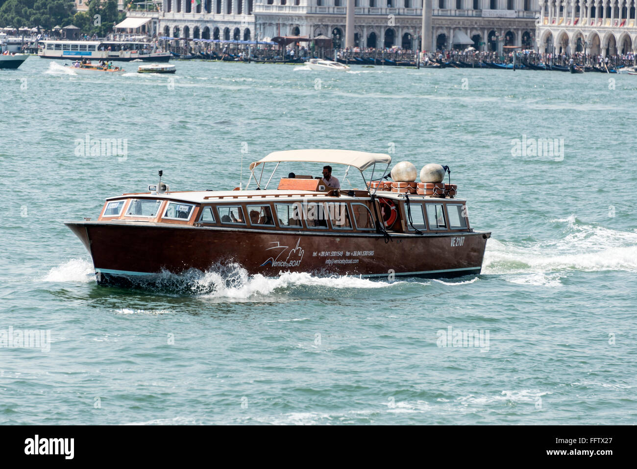 One of the many tourist excursion boats that ply the Venetian Lagoon in ...