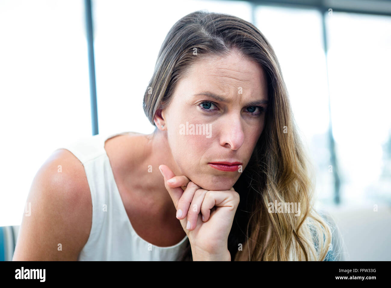 thoughtful woman looking  at the camera Stock Photo