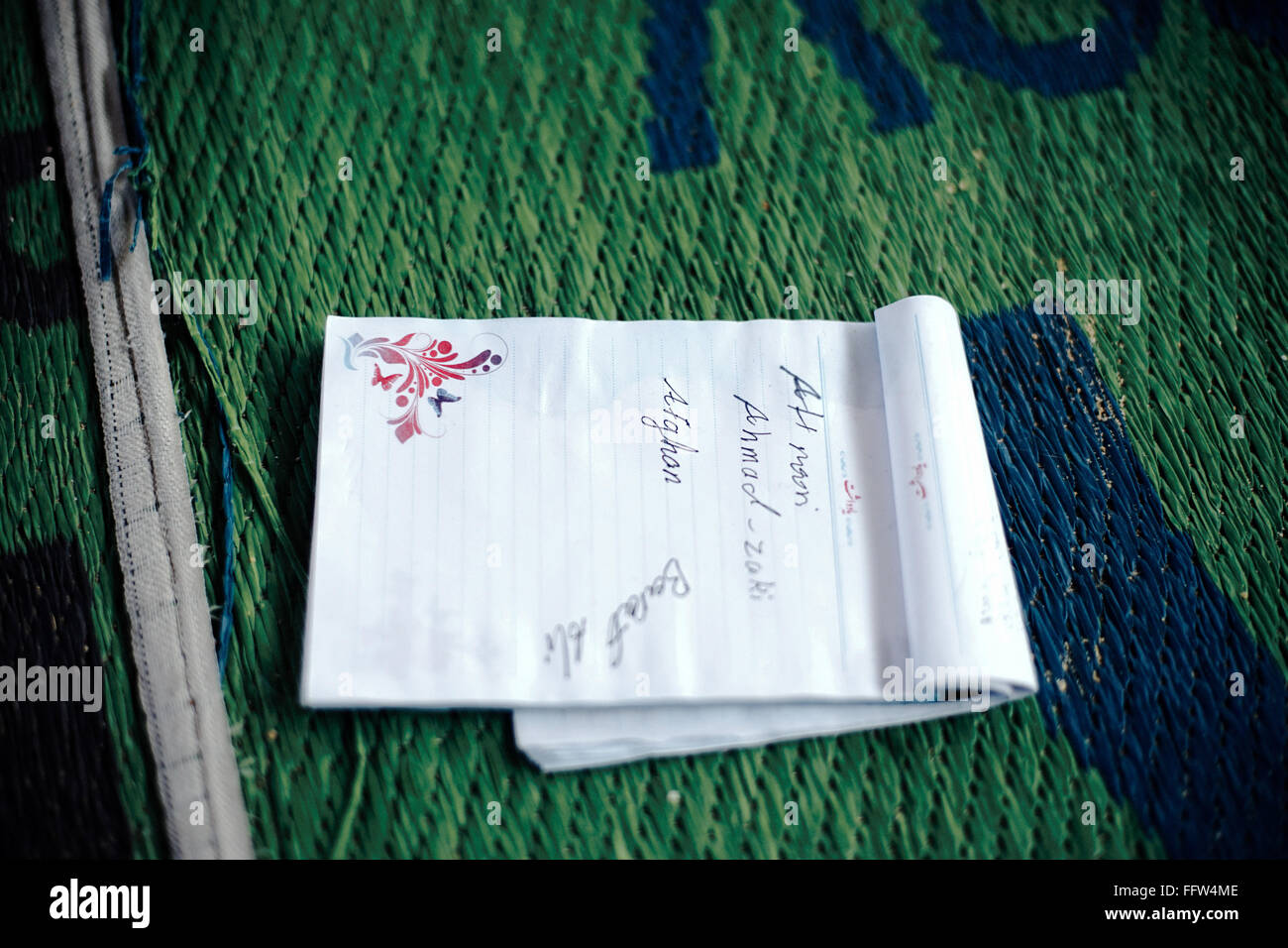 Migrants on Chios Island -  04/01/2016  -  Greece / Cyclades (the) / Chios island  -  Notebook forgotten on a mat in UNHCR hot s Stock Photo