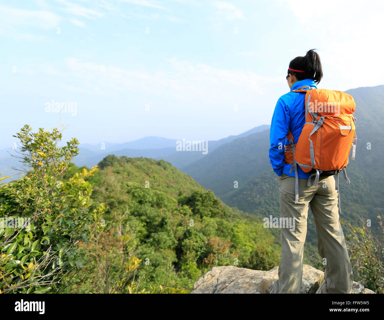 young woman backpacker hiking at mountain peak Stock Photo - Alamy