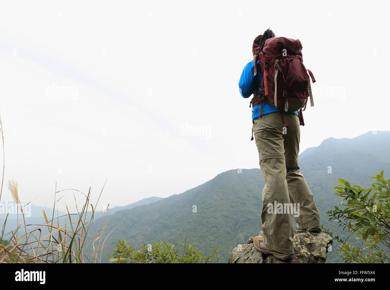 young woman hiker hiking at mountain peak Stock Photo - Alamy