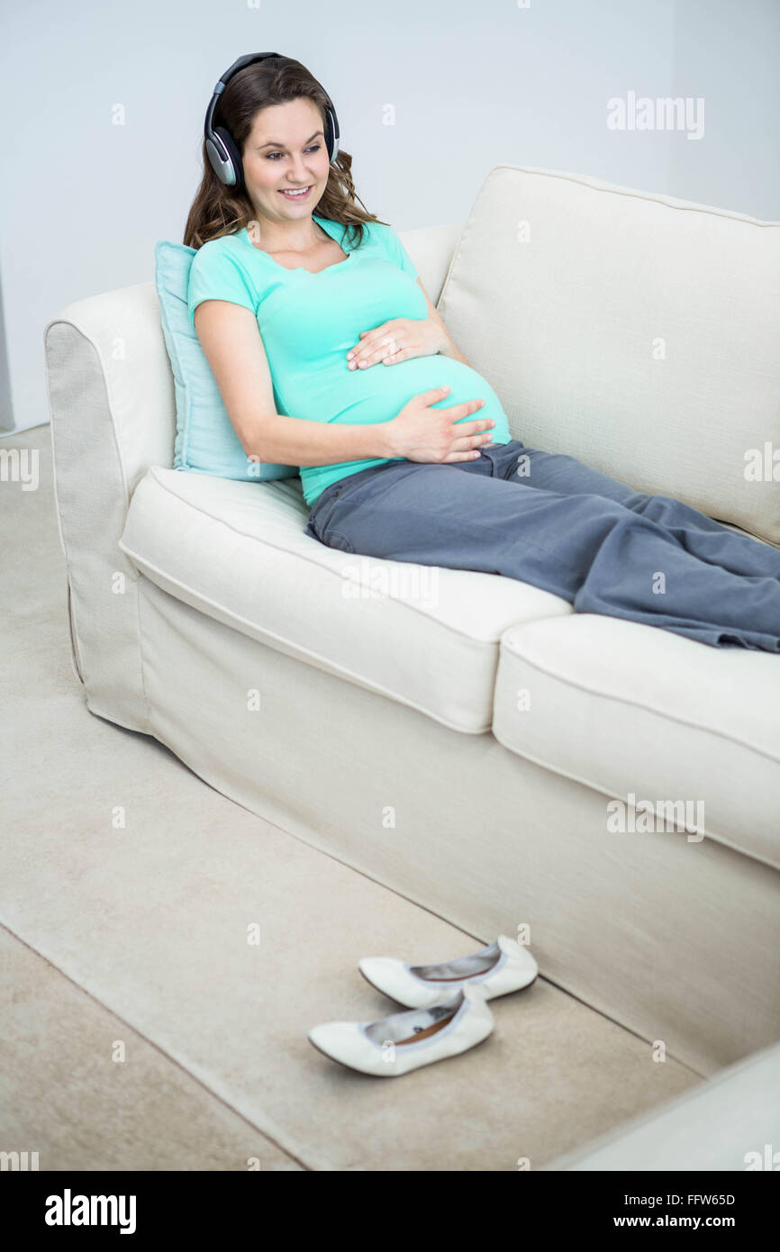 Pregnant woman listening to music Stock Photo - Alamy