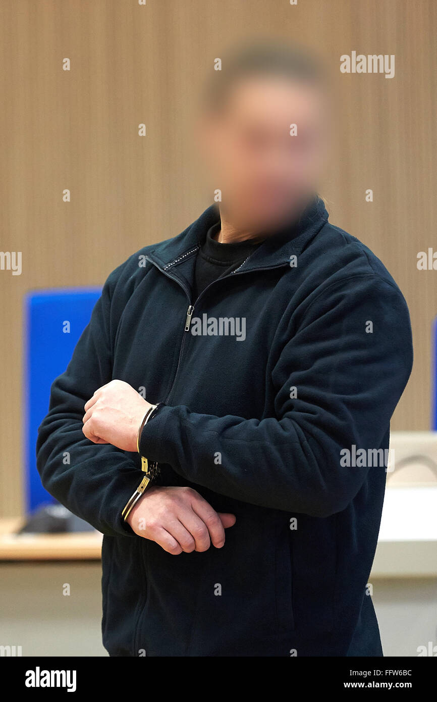 Koblenz, Germany. 17th Feb, 2016. The defendant Karl-Heinz B. arrives in handcuffs on the third day of trial against nine members of the Hells Angels biker gang in the regional court in Koblenz, Germany, 17 February 2016. The defendants are being accused of kidnapping, extortion under threat of force, battery, and assault. Photo: THOMAS FREY/dpa (ATTENTION EDITORS: Defendant made unidentifiable for reasons of personal rights)/dpa/Alamy Live News Stock Photo