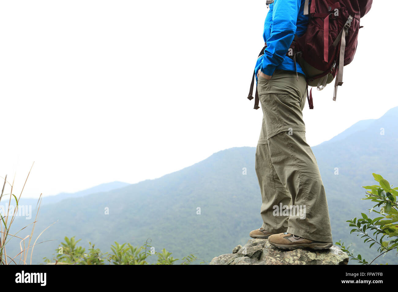 young woman backpacker hiking at mountain peak Stock Photo - Alamy