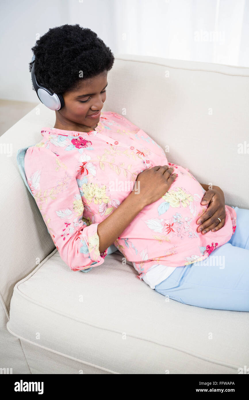 Pregnant woman listening to music Stock Photo - Alamy