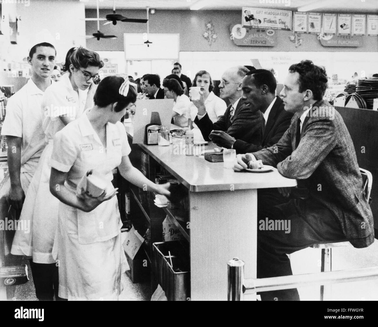 LUNCH COUNTER SIT-IN, 1960. /nLunch counter employees at a Peoples Drug store in Arlington, Virginia, preparing to close early while black and white customers stage a sit-in demonstration, 9 June 1960. Stock Photo