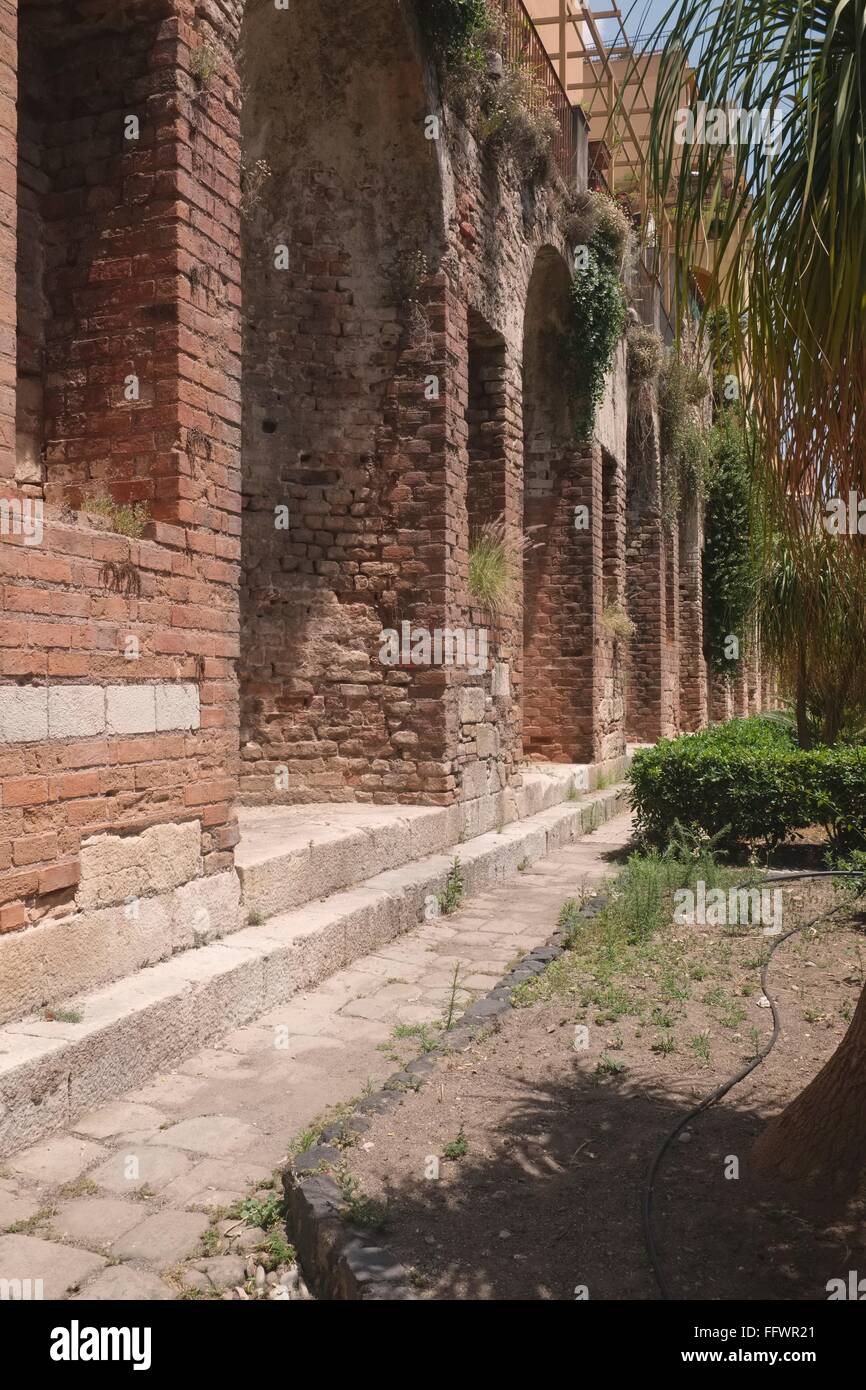Ancient Roman remains, thought to be Cisterns form foundations for later residential buildings in Taormina Stock Photo