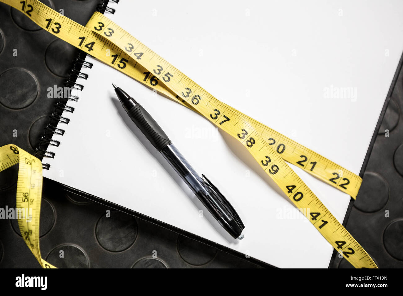 Notepad and measuring tape Stock Photo Alamy