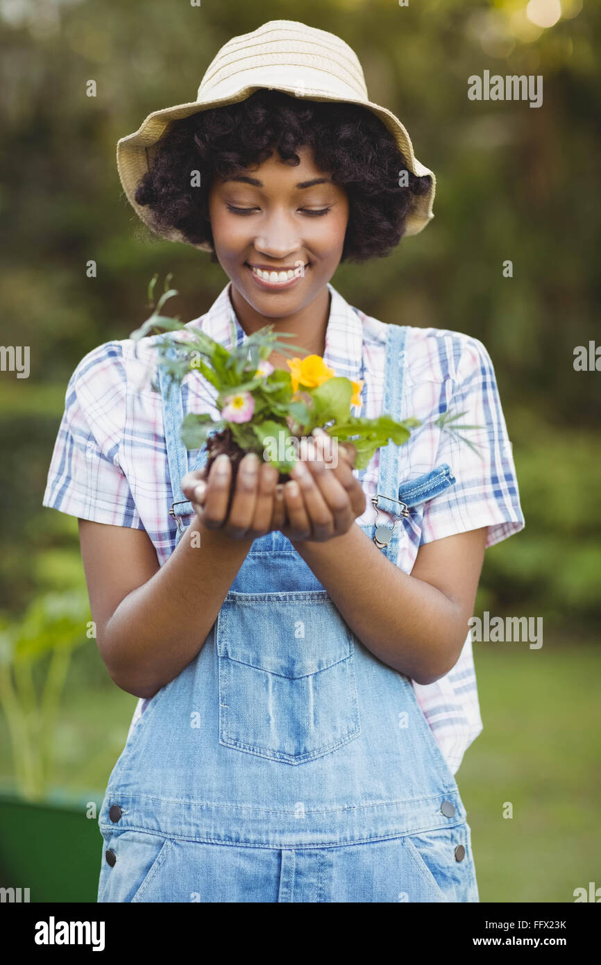 Smiling woman holding flowers Stock Photo - Alamy
