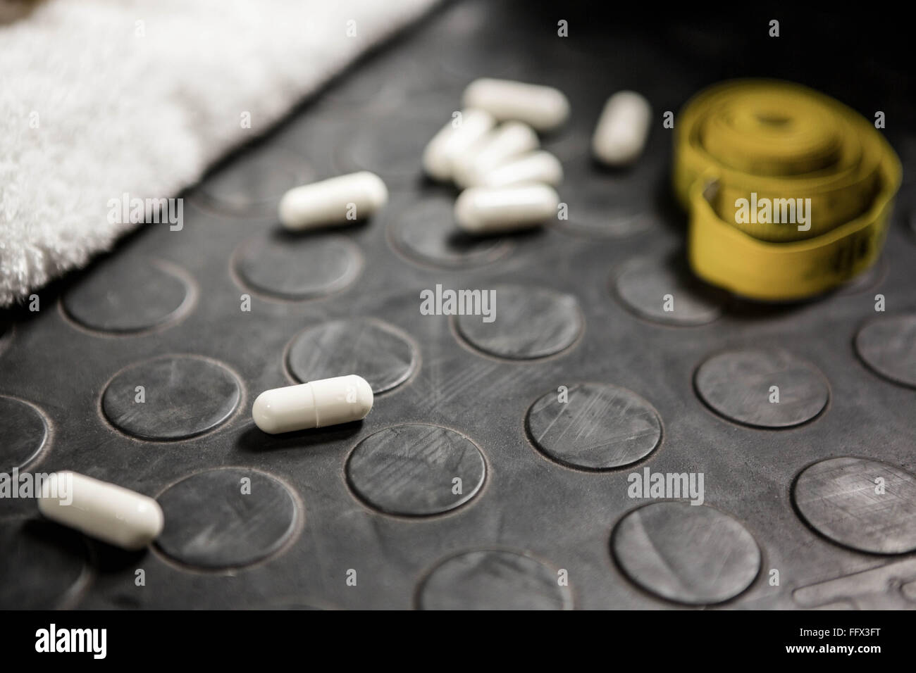 Pills and measuring tape Stock Photo