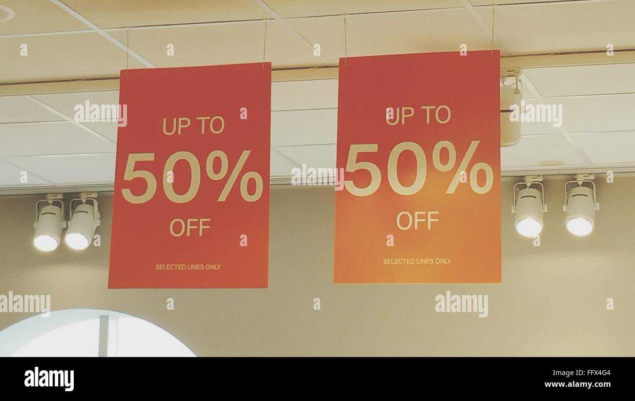 Commercial Posters Hanging From Ceiling Against Spotlights At Mall Stock Photo Alamy