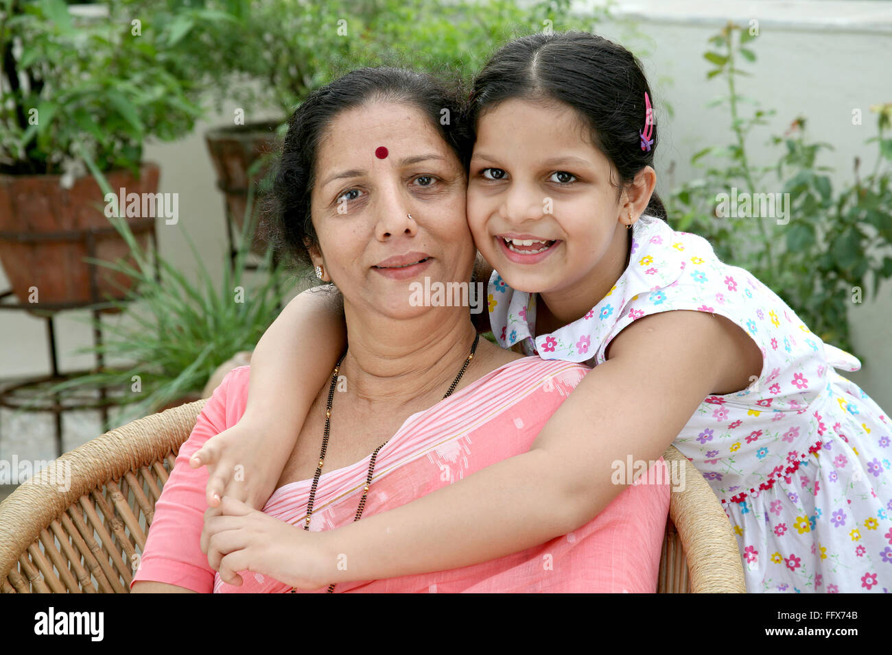 whipping mature granny Old lady granny and small girl grand daughter holding behind with hands  over shoulder MR # 687G and 687J Stock Photo - Alamy