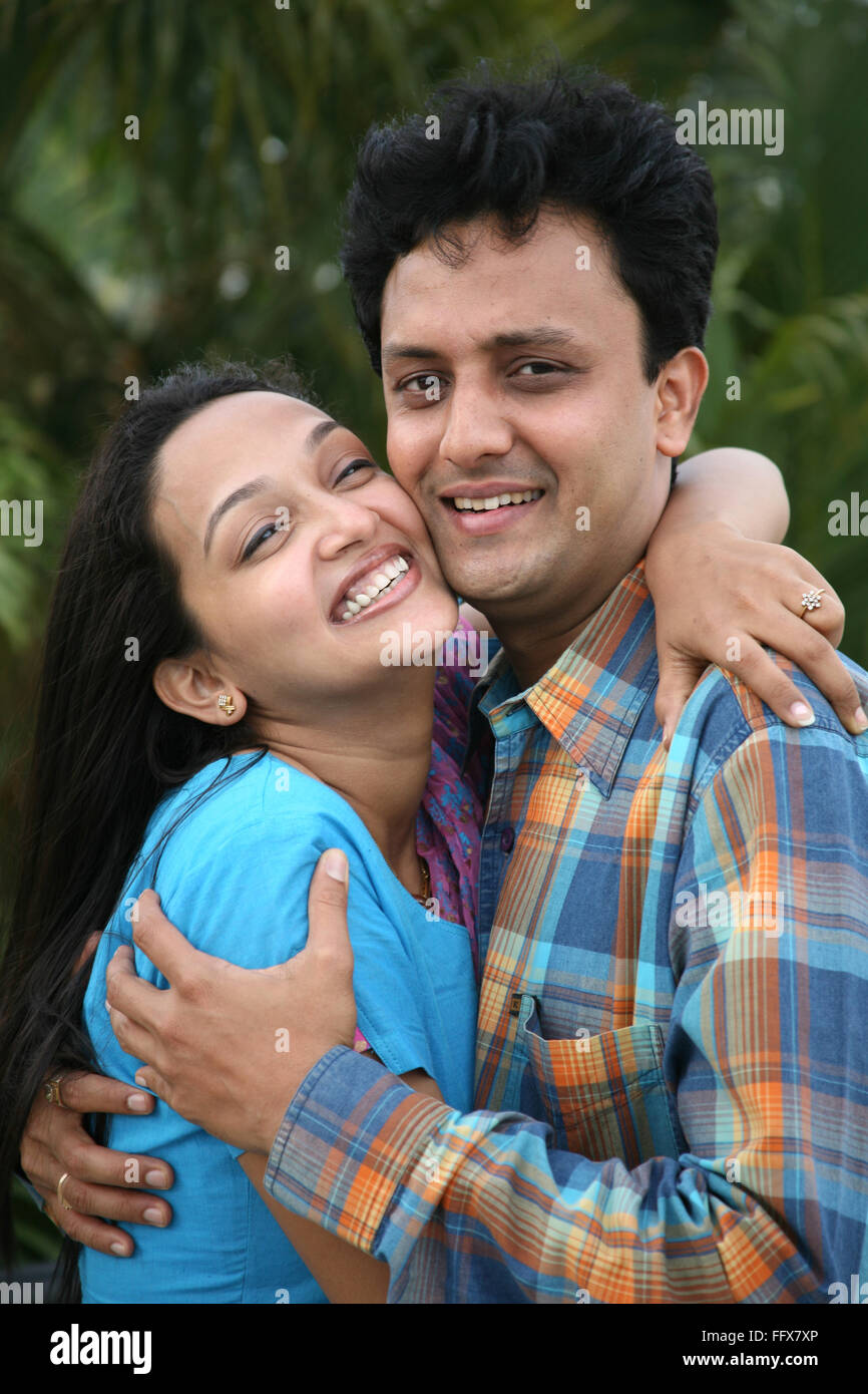 South Asian Indian young man and woman touching cheeks of each other ...