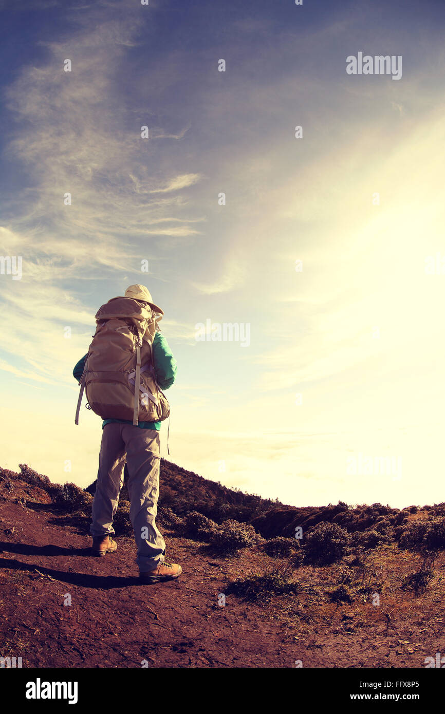 young woman backpacker hiking on mountain peak Stock Photo - Alamy