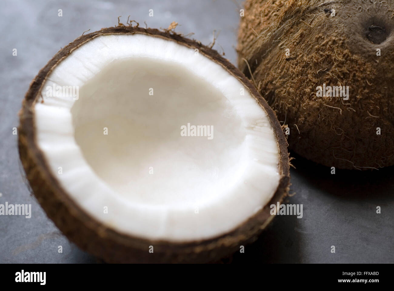 Coconut cut half inside white Stock Photo - Alamy