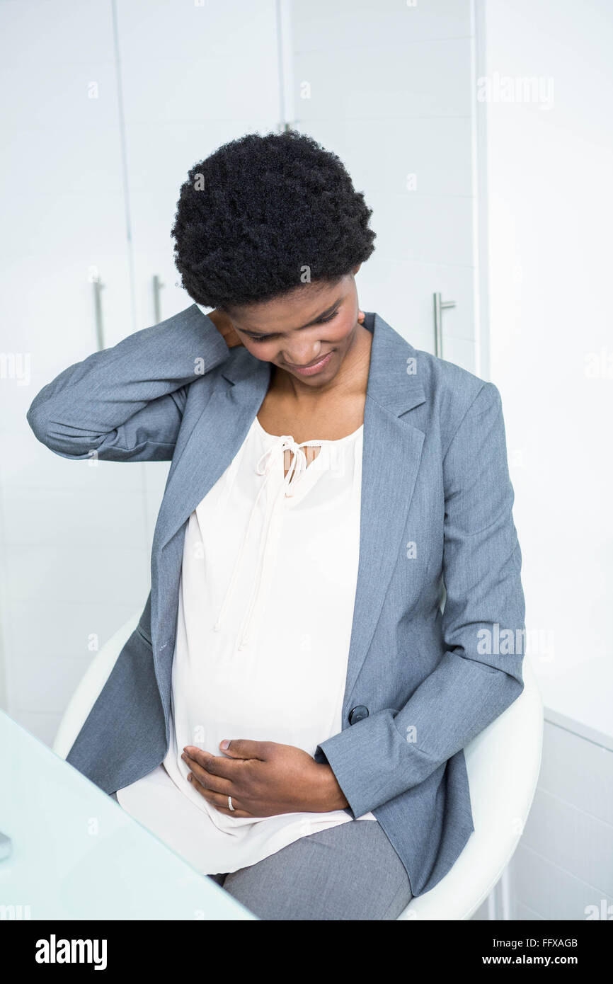 Pregnant businesswoman with neck pain Stock Photo Alamy