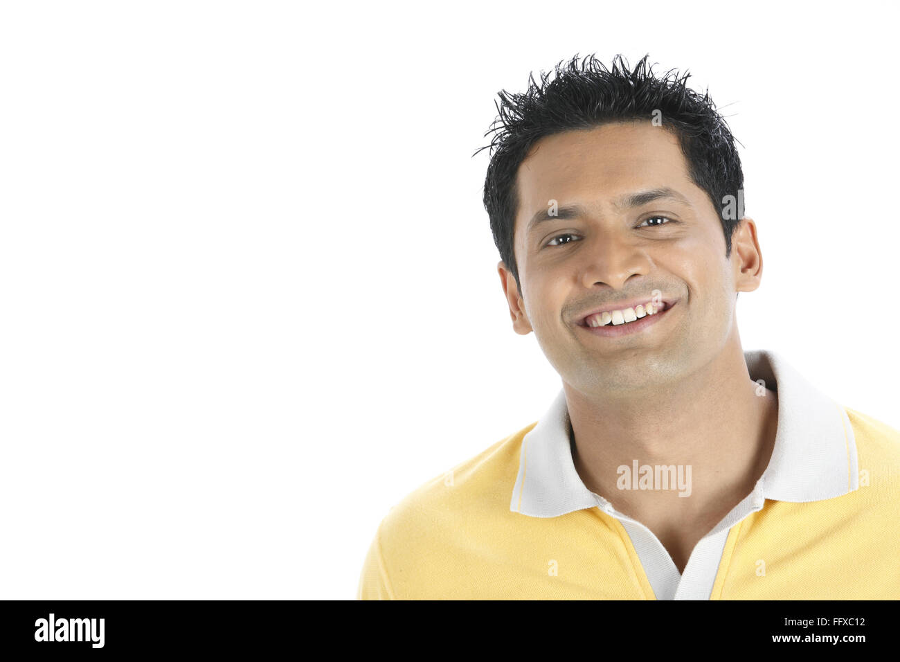 Confident young man wearing yellow t shirt MR#703R Stock Photo