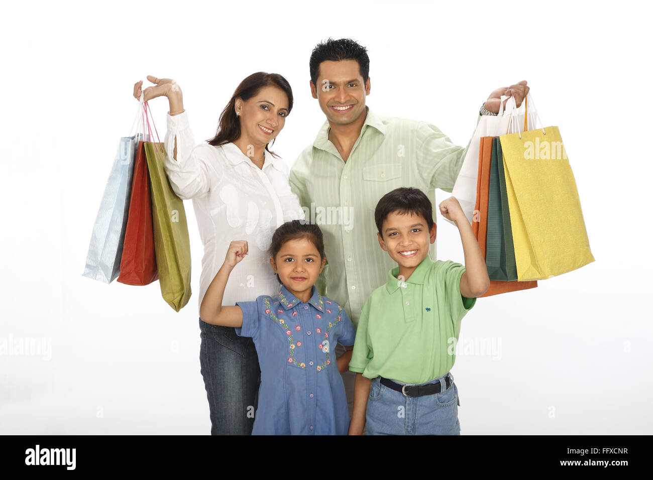 Parent , showing , colourful , shopping , bags , standing , with , children , MR#703N,703O,703R,703S Stock Photo