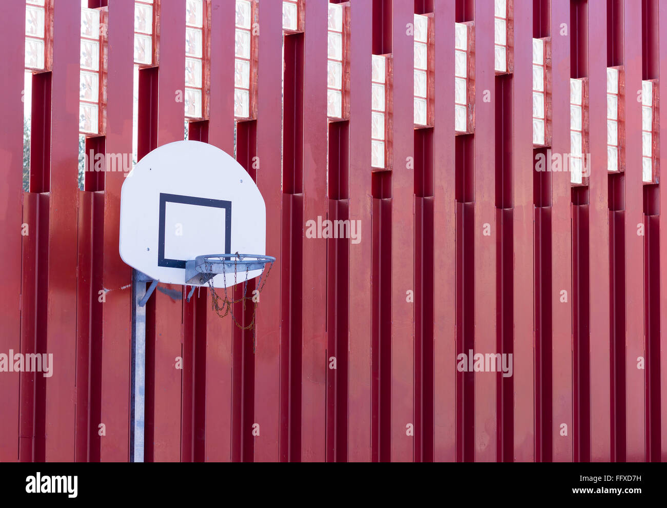 Basketball hoop on red metallic wall structure Stock Photo