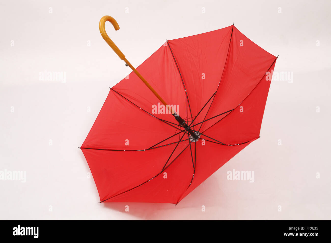 Red umbrella open upside down on white floor Stock Photo Alamy