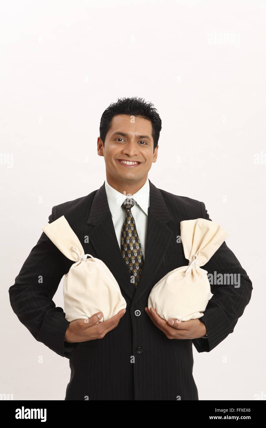 Businessman holding money bag in both hands MR#703T Stock Photo - Alamy
