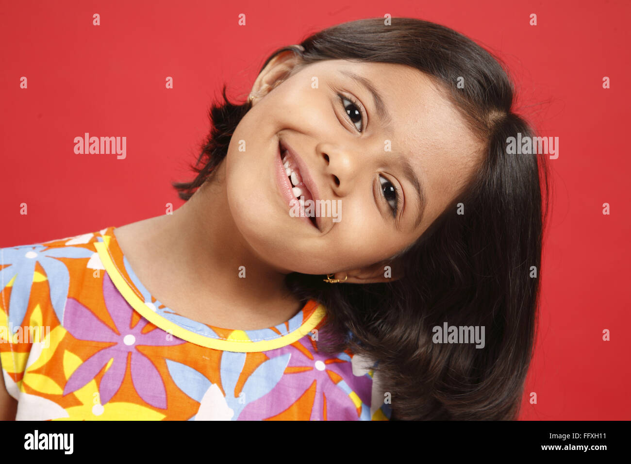 Eight year old girl tilted head on left side MR#703U Stock Photo