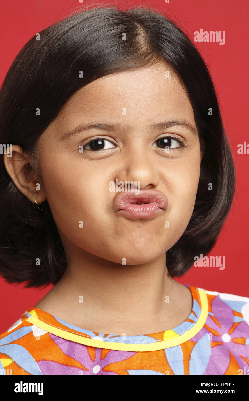 Eight year old girl making funny lips and face expression MR703U Stock