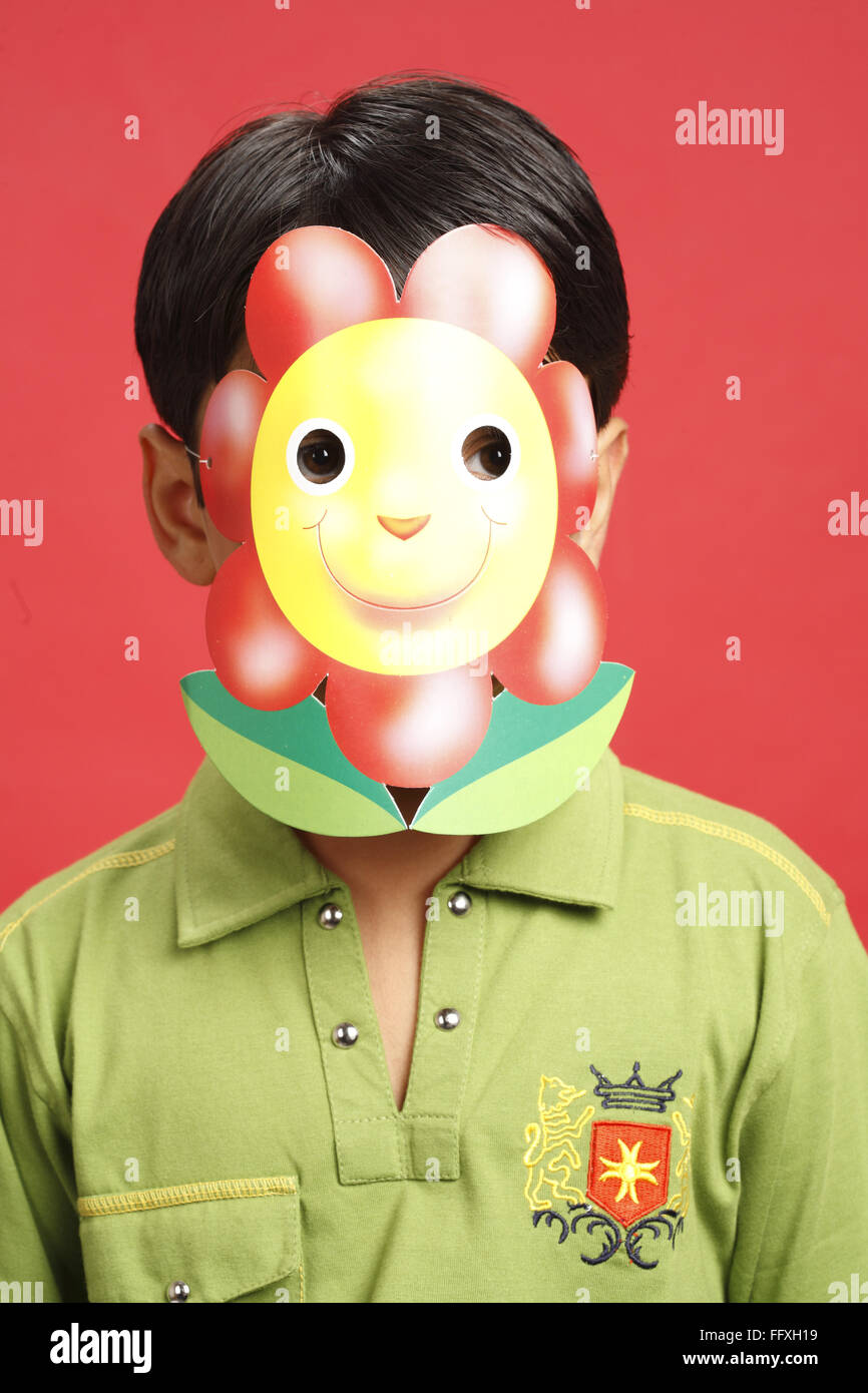 Ten year old boy wearing paper mask with flower printed on it MR703V