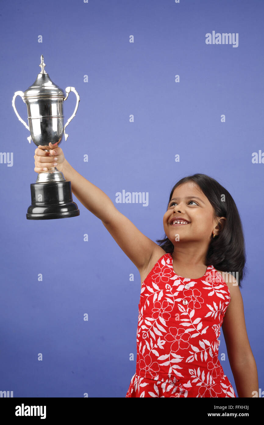 Eight year old girl raising trophy MR#703U Stock Photo