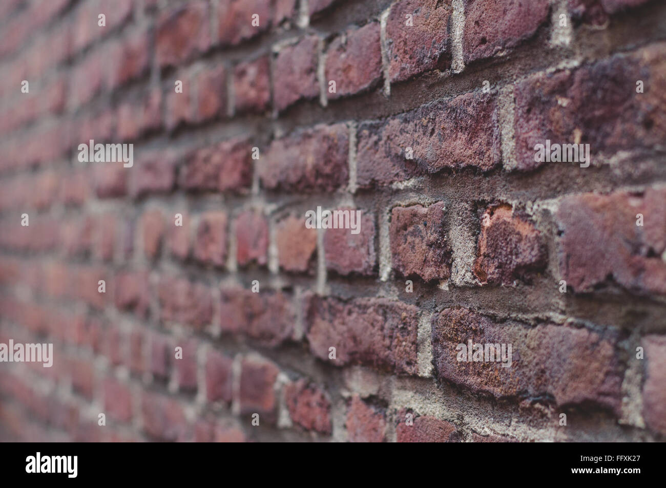 Old brick wall closeup background, shallow depth of field Stock Photo